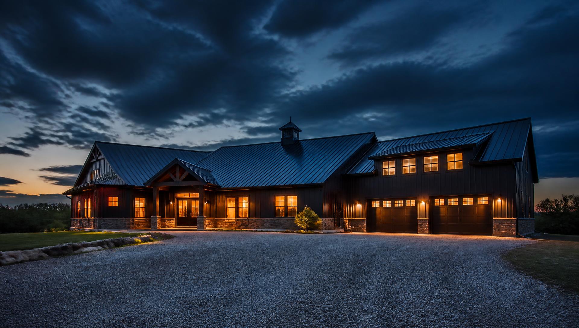 Barndominium at dusk with warm interior lighting